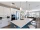 Kitchen featuring white cabinetry, stainless steel appliances, and a large island with seating at 222 Willow Ave, Anna Maria, FL 34216