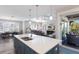 Open-concept kitchen features a large island with seating and a view to the outdoor patio at 222 Willow Ave, Anna Maria, FL 34216