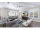 Cozy living room features tray ceilings, plantation shutters, hardwood floors, and comfortable seating at 222 Willow Ave, Anna Maria, FL 34216