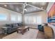 Cozy living room featuring a textured ceiling, comfortable seating, and natural light at 222 Willow Ave, Anna Maria, FL 34216