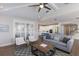 Bright open-concept living room with modern furnishings, ceiling fan, and an open flow to the kitchen at 222 Willow Ave, Anna Maria, FL 34216