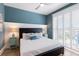 Comfortable main bedroom with shutters, shiplap detail, and stylish blue accent wall at 222 Willow Ave, Anna Maria, FL 34216