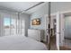 Airy main bedroom with adjacent bathroom, tall ceilings, and modern decor at 222 Willow Ave, Anna Maria, FL 34216