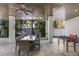 Outdoor living area with grill, dining table, and a foosball table at 222 Willow Ave, Anna Maria, FL 34216