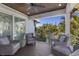 Inviting covered patio featuring wicker seating and a ceiling fan at 222 Willow Ave, Anna Maria, FL 34216