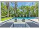 Experience resort-style living with a sparkling pool, relaxing spa, and lush tropical landscaping for the perfect outdoor escape at 222 Willow Ave, Anna Maria, FL 34216