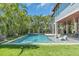 Captivating pool area with spiral staircase, surrounded by lush palms at 222 Willow Ave, Anna Maria, FL 34216