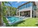 A resort-style pool and spa are the focal point, complemented by an outdoor spiral staircase and verdant landscaping at 222 Willow Ave, Anna Maria, FL 34216