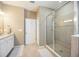 Well-lit bathroom with a glass enclosed shower featuring tiled walls and floors at 2239 Ellarose Cir, Sarasota, FL 34232