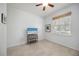 Bright bedroom featuring tile flooring, window, and dresser with mounted television at 2239 Ellarose Cir, Sarasota, FL 34232