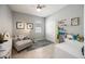 Cozy bedroom with a gray chaise lounge, white closet, and tile flooring at 2239 Ellarose Cir, Sarasota, FL 34232