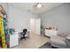 Well-lit room with desk, gray chaise lounge, white closet, and tile flooring at 2239 Ellarose Cir, Sarasota, FL 34232