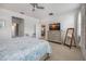 Spacious bedroom with light tile, ceiling fan, dresser, TV, and doorway to other rooms at 2239 Ellarose Cir, Sarasota, FL 34232