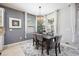 Well-lit dining area with a dark wood table, stylish chairs, and serene decor at 2239 Ellarose Cir, Sarasota, FL 34232