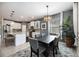 Stylish dining area next to the kitchen featuring modern light fixture and ample natural light at 2239 Ellarose Cir, Sarasota, FL 34232