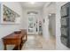 Bright and airy foyer featuring tile flooring, a console table, and an arched transom window at 2239 Ellarose Cir, Sarasota, FL 34232