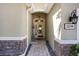Inviting front entry featuring stone accents, a covered porch, and a glass front door at 2239 Ellarose Cir, Sarasota, FL 34232