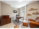 Inviting home office featuring a leather chair, desk, wood furnishings, and decorative shelving at 2239 Ellarose Cir, Sarasota, FL 34232
