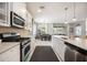 Bright kitchen featuring stainless appliances, a smooth cooktop, and white shaker cabinets at 2239 Ellarose Cir, Sarasota, FL 34232