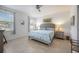 Cozy main bedroom with a ceiling fan, two windows, and neutral decor at 2239 Ellarose Cir, Sarasota, FL 34232