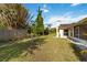 Backyard features a lawn and mature landscaping with an enclosed patio at 2271 Pine View Cir, Sarasota, FL 34231