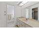 Bright bathroom featuring a vanity with sink, mirror, and doorway to shower at 2271 Pine View Cir, Sarasota, FL 34231