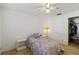 Comfortable bedroom featuring carpeted floors, a ceiling fan, and a closet for storage at 2271 Pine View Cir, Sarasota, FL 34231