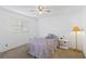 Bright bedroom featuring a ceiling fan and a window with views of the outdoors at 2271 Pine View Cir, Sarasota, FL 34231