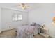 Serene bedroom with natural light, carpet flooring, and a ceiling fan at 2271 Pine View Cir, Sarasota, FL 34231