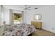 Bedroom featuring a sliding glass door to patio, dresser, and ceiling fan at 2271 Pine View Cir, Sarasota, FL 34231