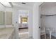Bathroom view of a bedroom with a floral bedspread and sliding glass doors at 2271 Pine View Cir, Sarasota, FL 34231