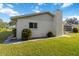 Exterior view of a home with stucco siding, a chimney, and neat landscaping at 2271 Pine View Cir, Sarasota, FL 34231