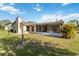 Charming home with a screened lanai, lush lawn, and inviting outdoor space for relaxation at 2271 Pine View Cir, Sarasota, FL 34231