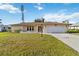 Attractive single-story home with an attached garage and well maintained landscaping at 2271 Pine View Cir, Sarasota, FL 34231