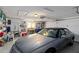 The garage is well-lit with ample storage shelves and contains a silver car at 2271 Pine View Cir, Sarasota, FL 34231