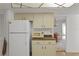 Kitchen features white appliances and cabinets with a pass-through to the dining room at 2271 Pine View Cir, Sarasota, FL 34231