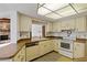 Bright kitchen with white appliances and vintage cabinetry, adjacent to living space at 2271 Pine View Cir, Sarasota, FL 34231