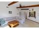 Comfortable living area with exposed beams, a stone fireplace, and ample seating at 2271 Pine View Cir, Sarasota, FL 34231