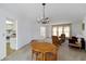The living room features a chandelier, neutral carpet, and natural light at 2271 Pine View Cir, Sarasota, FL 34231