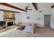 Gathering room with beamed ceiling, stone fireplace, and comfortable seating area at 2271 Pine View Cir, Sarasota, FL 34231
