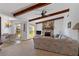 Inviting living room with a stone fireplace and exposed wood beam ceilings at 2271 Pine View Cir, Sarasota, FL 34231