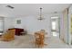 Open-concept living area featuring a dining table, neutral carpet, and natural light at 2271 Pine View Cir, Sarasota, FL 34231