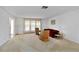 Bright and open living room features a large window, ample seating and neutral carpeting at 2271 Pine View Cir, Sarasota, FL 34231