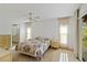 Bright main bedroom with carpet flooring, ceiling fan, and ensuite bathroom access at 2271 Pine View Cir, Sarasota, FL 34231