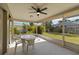 Enclosed patio features a ceiling fan, screen windows and furniture at 2271 Pine View Cir, Sarasota, FL 34231