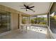 Tranquil screened patio with a ceiling fan, offering serene views of the backyard's mature landscaping at 2271 Pine View Cir, Sarasota, FL 34231