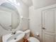 Cozy bathroom featuring a modern round mirror and white fixtures at 238 Cape Harbour Loop # 104, Bradenton, FL 34212
