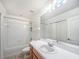 Bathroom featuring a shower-tub combo, white tile, and a large vanity mirror at 238 Cape Harbour Loop # 104, Bradenton, FL 34212