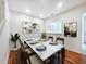 Elegant dining room with marble-top table, stylish chairs, and modern artwork; perfect for entertaining guests at 238 Cape Harbour Loop # 104, Bradenton, FL 34212