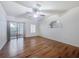 Spacious living room boasting wood floors, a ceiling fan, and sliding glass doors, perfect for relaxation at 238 Cape Harbour Loop # 104, Bradenton, FL 34212